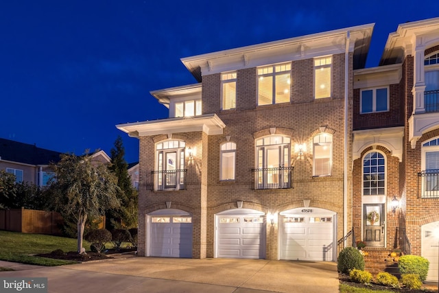 view of front facade with driveway, an attached garage, and brick siding