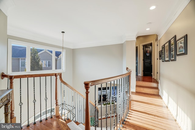 stairway with recessed lighting, crown molding, and wood finished floors