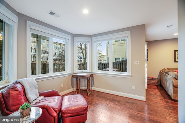 living area with baseboards, visible vents, dark wood finished floors, and recessed lighting