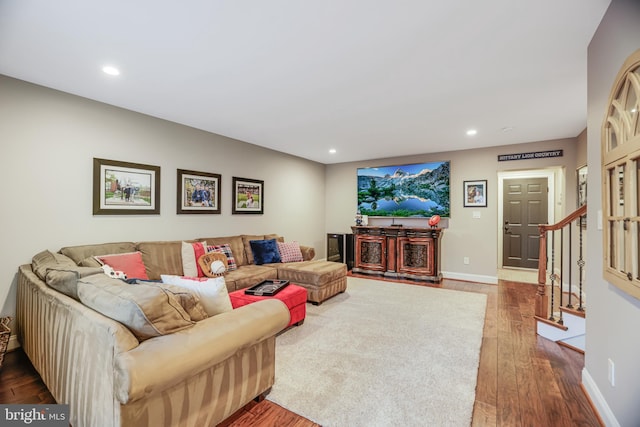 living area featuring stairs, recessed lighting, baseboards, and wood finished floors