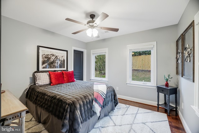 bedroom featuring ceiling fan, wood finished floors, and baseboards