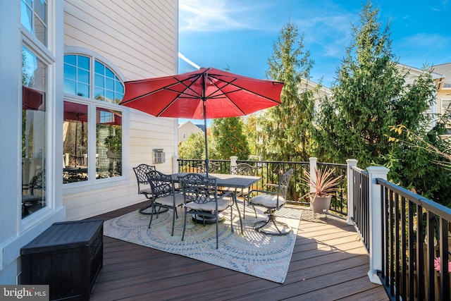 wooden terrace with outdoor dining space