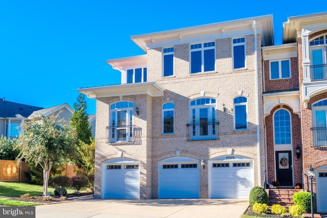 view of front of property featuring a garage, brick siding, and driveway