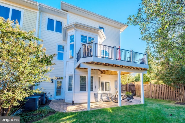 rear view of house with central AC, a patio, a lawn, and fence