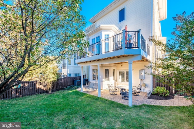 rear view of house with a yard, a fenced backyard, a patio, and central air condition unit