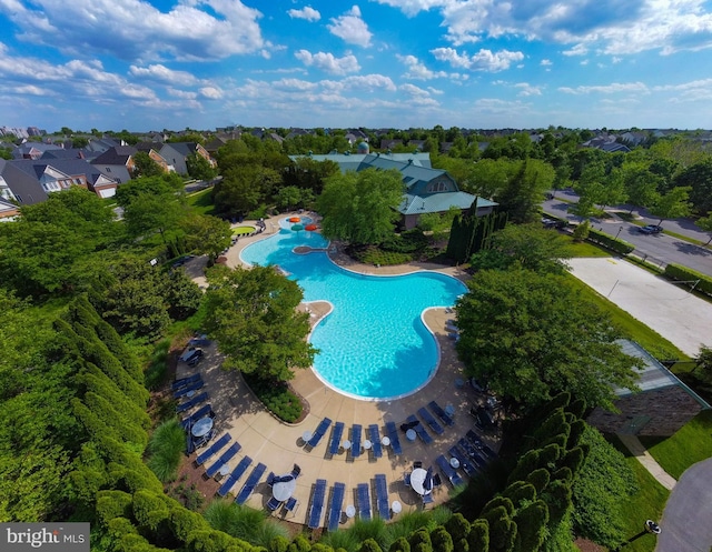 community pool with a patio and a residential view