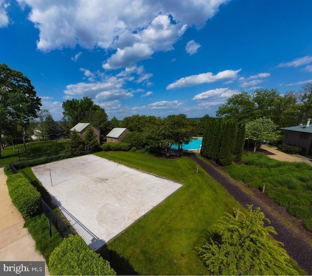 exterior space featuring a lawn and volleyball court