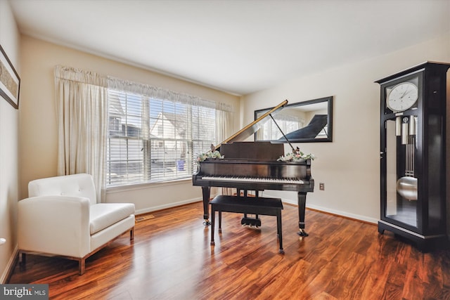 sitting room with baseboards and wood finished floors