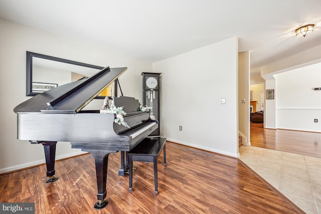 living area featuring baseboards and wood finished floors