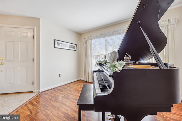 interior space featuring baseboards and wood finished floors