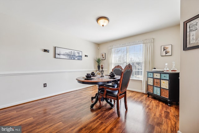 dining area with wood finished floors and baseboards