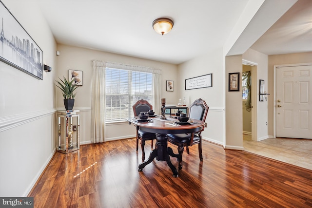 dining area with wood finished floors and baseboards