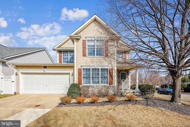 traditional home featuring a garage, concrete driveway, and fence