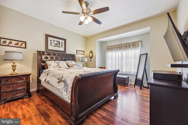 bedroom featuring dark wood-style floors, ceiling fan, and baseboards