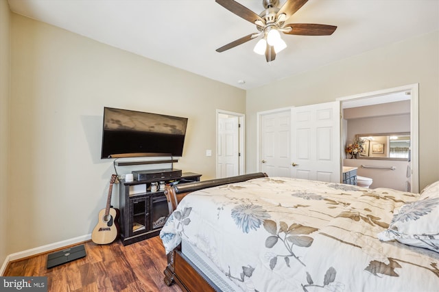 bedroom featuring a ceiling fan, dark wood finished floors, baseboards, and ensuite bathroom