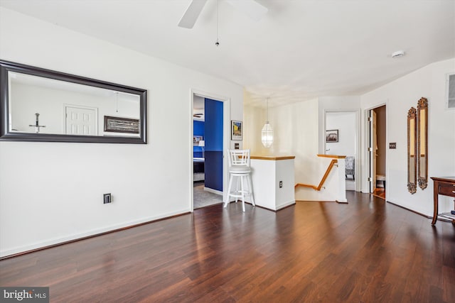 spare room with ceiling fan, baseboards, and wood finished floors