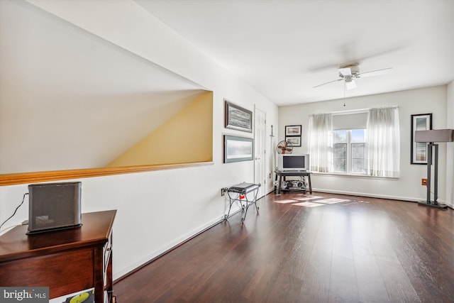 living area with ceiling fan, baseboards, and wood finished floors