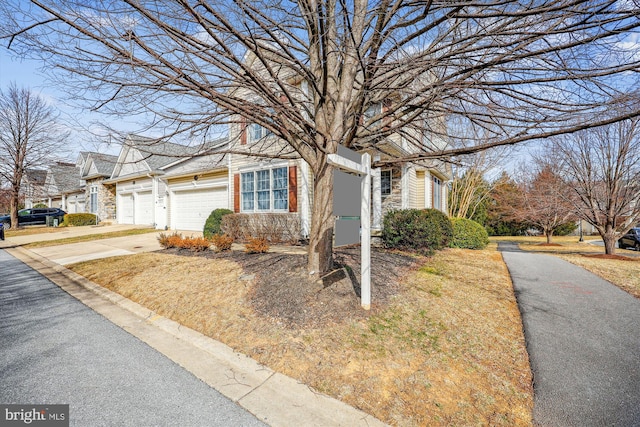 obstructed view of property with concrete driveway and an attached garage