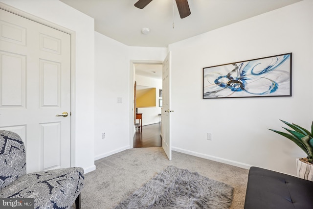 sitting room with carpet flooring, ceiling fan, and baseboards