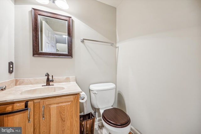 half bathroom with toilet and vanity