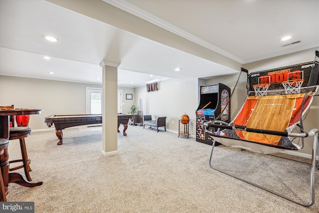 rec room with carpet floors, ornamental molding, visible vents, and baseboards