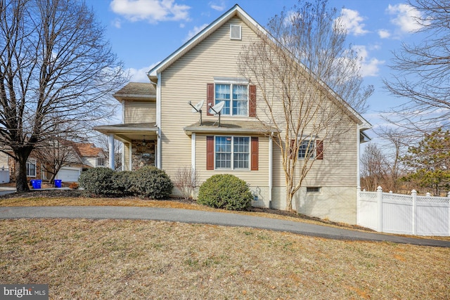 view of side of property with a yard and fence