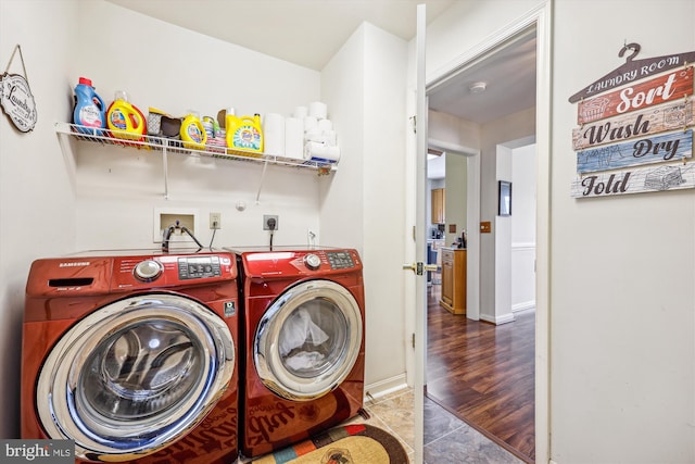 laundry room with tile patterned floors, baseboards, and washing machine and clothes dryer