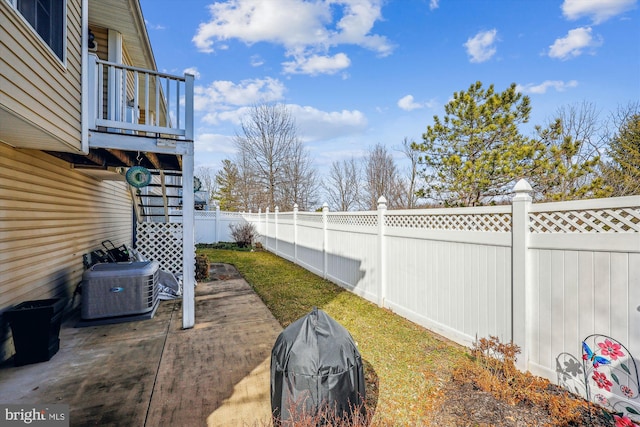 view of yard with a patio area, a fenced backyard, and central air condition unit