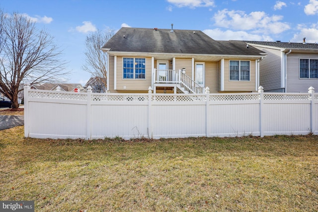 view of front of property with a fenced front yard and a front yard