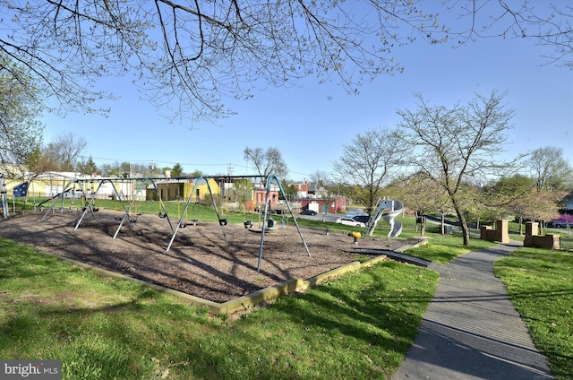 view of community featuring a lawn and playground community