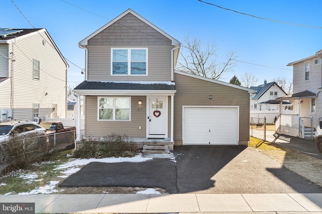 view of front of property with a garage, driveway, and fence