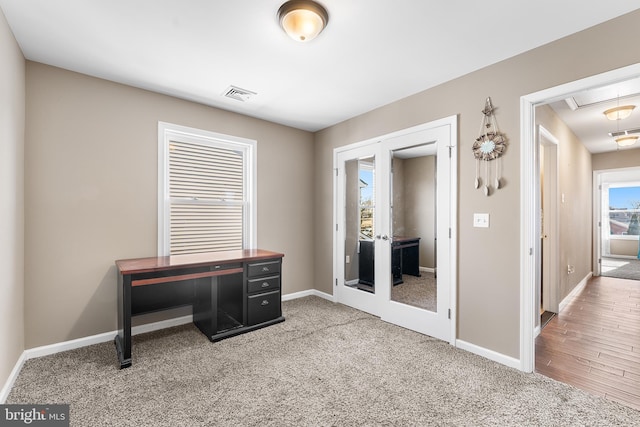 carpeted home office with visible vents, french doors, attic access, and baseboards