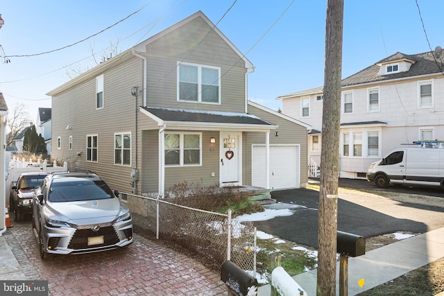 view of front of house with a fenced front yard and an attached garage