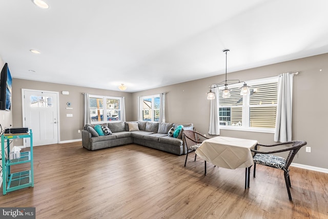 living area with recessed lighting, baseboards, and wood finished floors