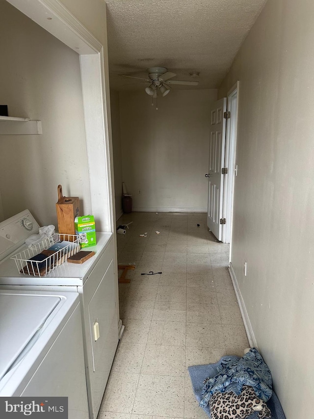 clothes washing area featuring ceiling fan, a textured ceiling, laundry area, light floors, and washing machine and clothes dryer