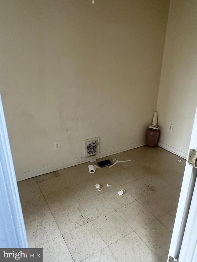 laundry room with baseboards and visible vents