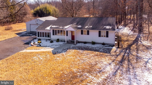 single story home featuring driveway and a shingled roof