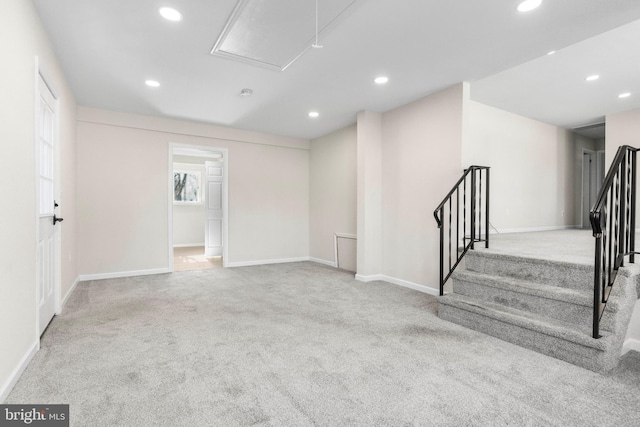 unfurnished room featuring light colored carpet, attic access, and recessed lighting