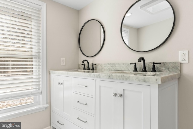 bathroom with double vanity and a sink