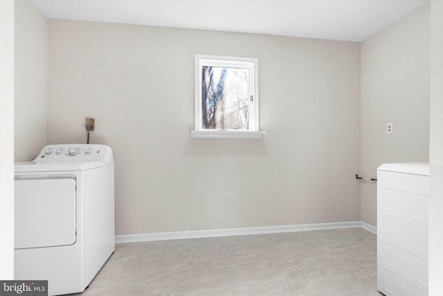 clothes washing area featuring laundry area, baseboards, and independent washer and dryer