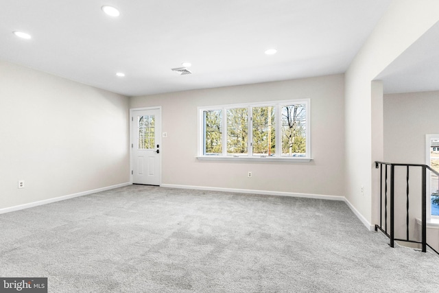 empty room featuring recessed lighting, visible vents, and light colored carpet