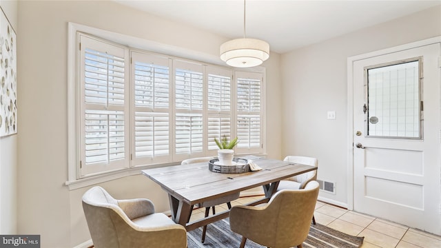 dining area featuring light tile patterned flooring and baseboards