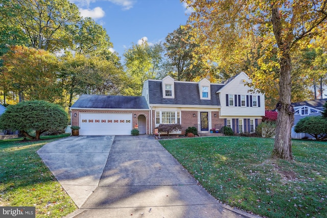 tri-level home with a garage, a front yard, brick siding, and driveway