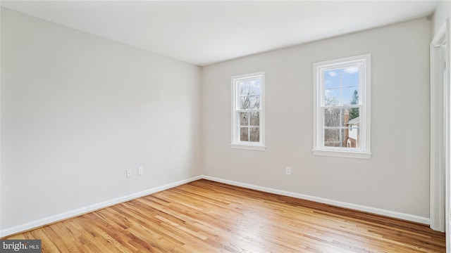 empty room with wood finished floors and baseboards