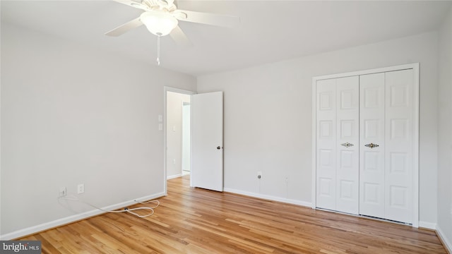 unfurnished bedroom with a closet, baseboards, ceiling fan, and light wood finished floors