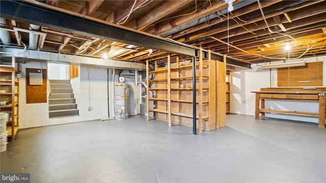 unfinished basement with water heater and stairway