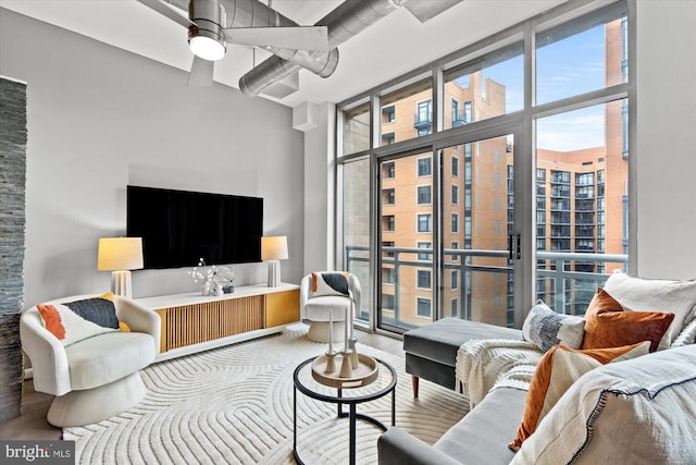 living room with floor to ceiling windows and ceiling fan