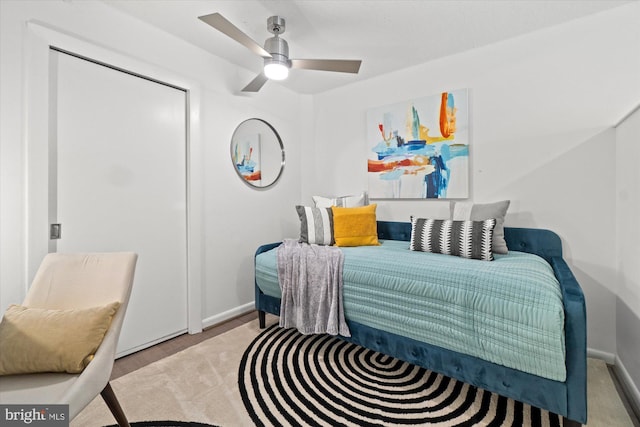 bedroom featuring a ceiling fan, baseboards, and wood finished floors