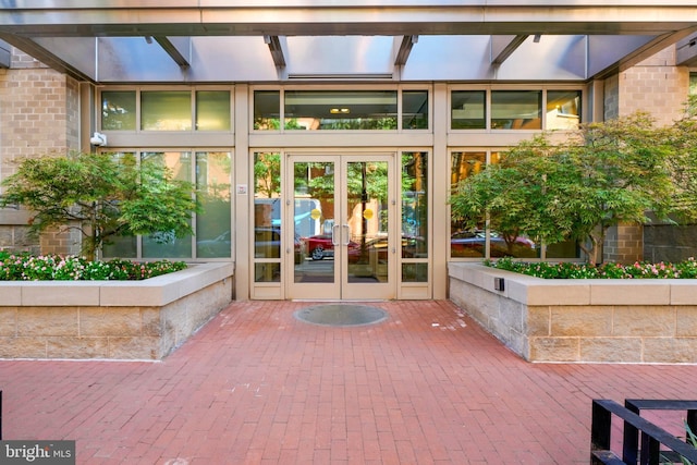 doorway to property featuring french doors and brick siding