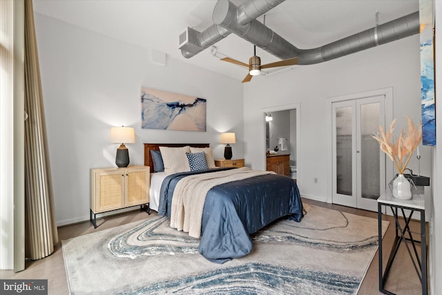 bedroom featuring french doors, connected bathroom, a ceiling fan, and baseboards